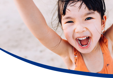 Smiling child enjoying a sunny trip, representing family travel rewards.